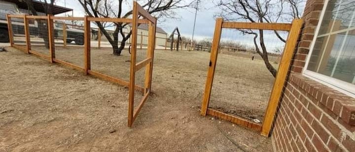 Ranch wire fencing with wooden posts and gate